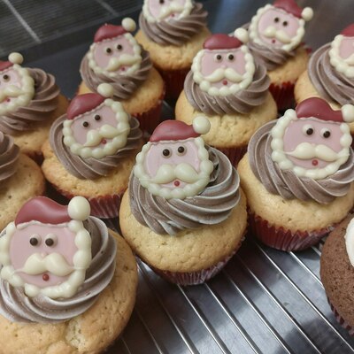 Hand made cupcakes decorated with chocolate Santa boot